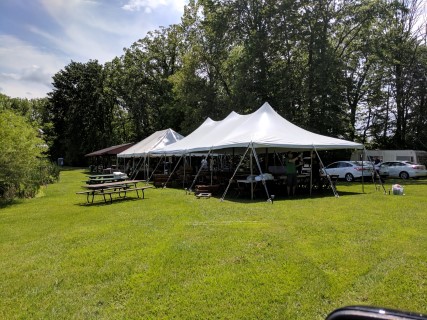 Wedding Reception at Campground - 20' x 40' Tent, Wooden Chairs, Rectangular and Round Tables.