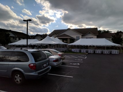 Corporate Event Family Dinner at Senior Living Facility - Three 20' x 40' Tents on Parking Lot and Sidewalk, White Padded Chairs, Rectangular Tables with White Plastic Table Covers (Quick 'Kwik' Covers).